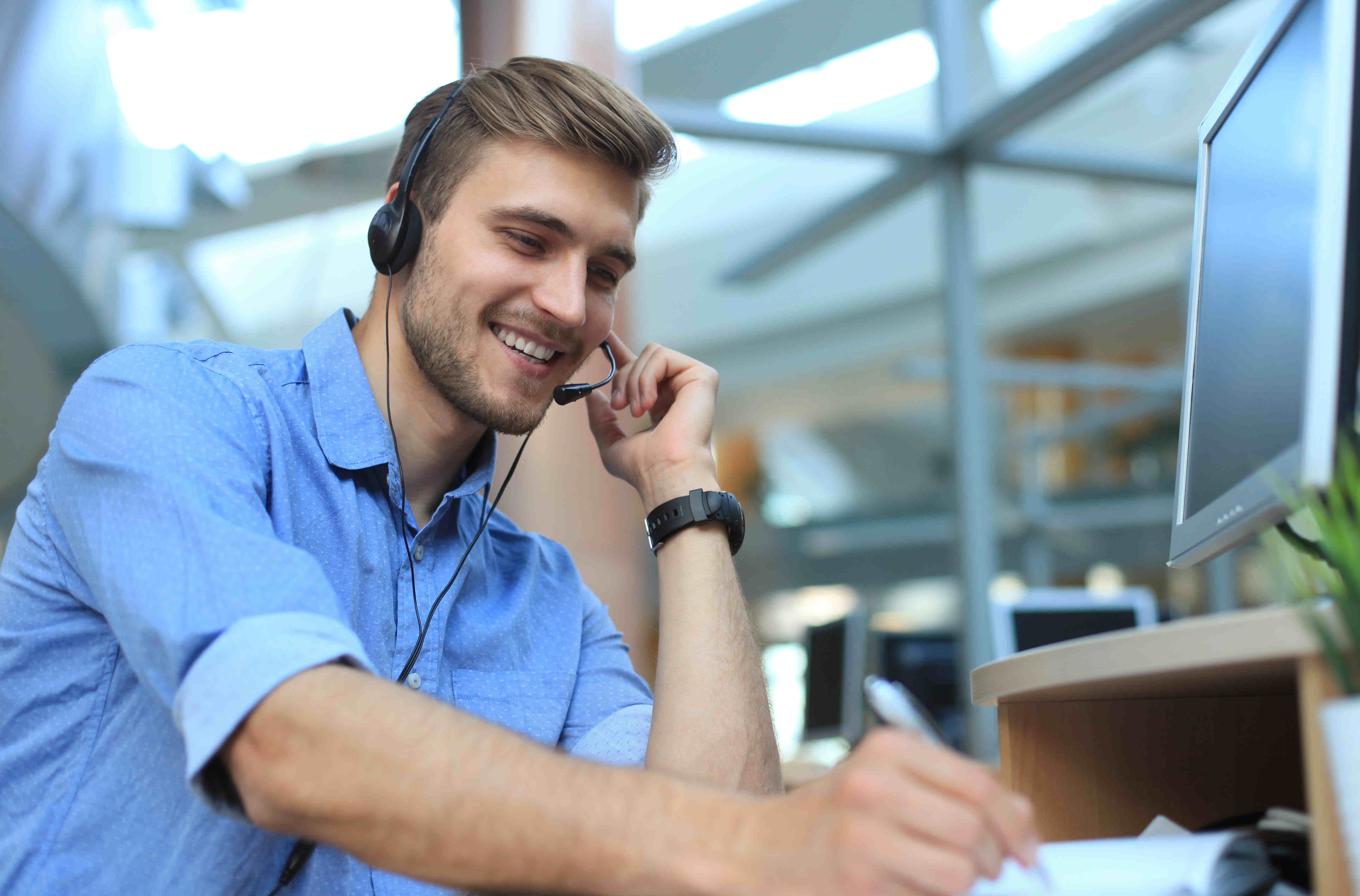 A man answering phone calls in a call centre